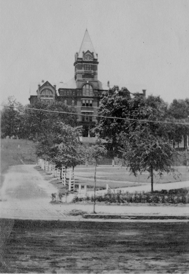 Archival photo of Tech Tower with oak trees featured in front.