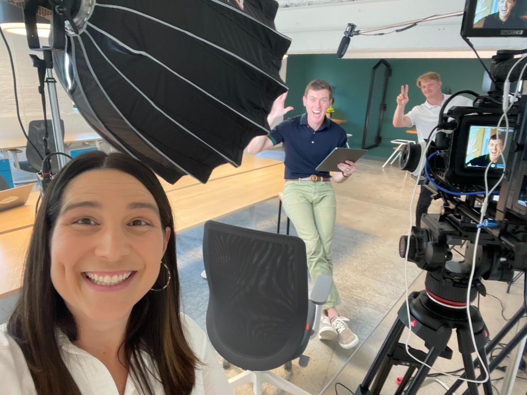 Meg taking a selfie on a film set with the CEO of the company